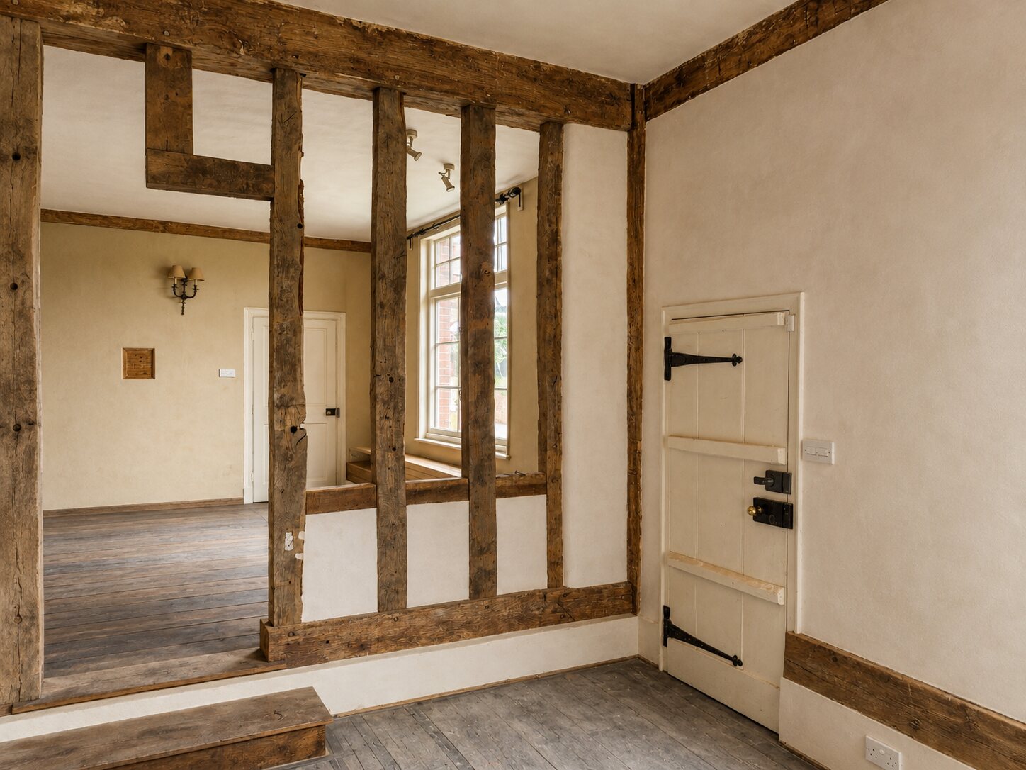 Finished lime plaster within a historic oak-framed interior