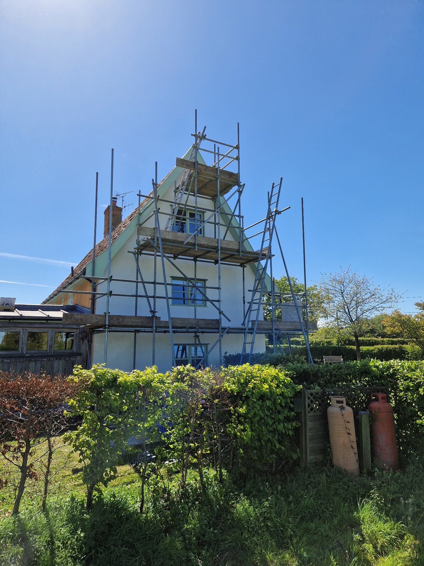 Restored lime-rendered gable on a Grade II listed timber-framed home